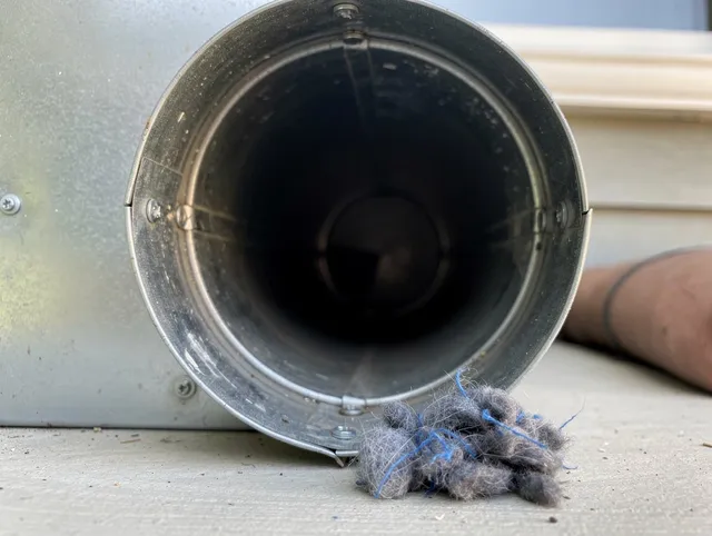 Columbus Dryer Vent Cleaning technician using specialized equipment to clear severe dryer vent blockage in Columbus